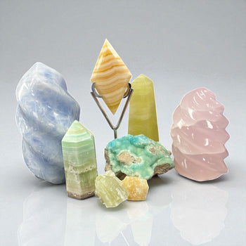A vibrant variety of Calcite crystals including Orange, Green, Zebra, Caribbean, and Optical on display at Raven’s Cauldron metaphysical shop.