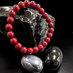 Power Trio Bundle: Black Obsidian gallet, silicon gallet, and cinnabar bracelet arranged on dark wood.