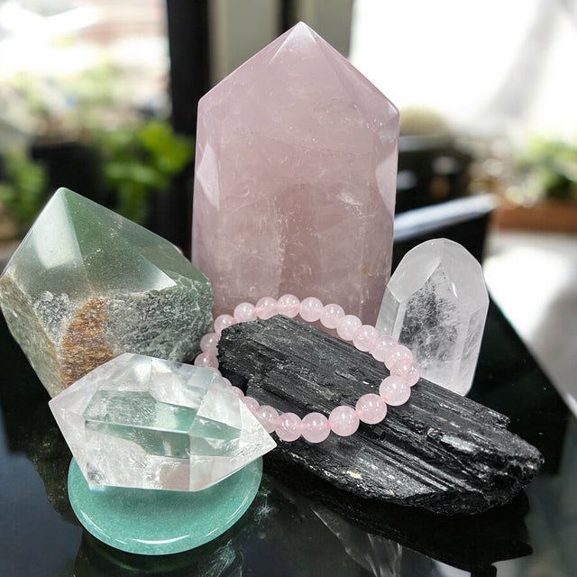 Healing crystal collection at Raven’s Cauldron featuring rose quartz, clear quartz, amethyst, black tourmaline, citrine, carnelian, and more.