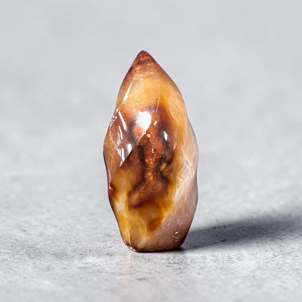 Polished Carnelian Flame crystal weighing 189 grams with a natural druzy pocket on the bottom, displaying rich orange and red coloring, Raven's Cauldron, Delaware, OH