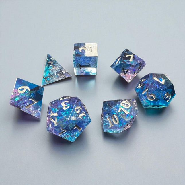 7-piece Blue and Purple Prismatic Dice Set with swirling resin and white numbering, designed for DnD and fantasy RPGs.