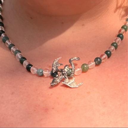Necklace with a dragon pendant worn on a person's neck