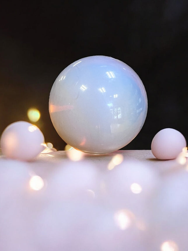 Close-up of Pink Opalite sphere reflecting light, available at Raven’s Cauldron, 6 N Sandusky St, Delaware, OH 43015