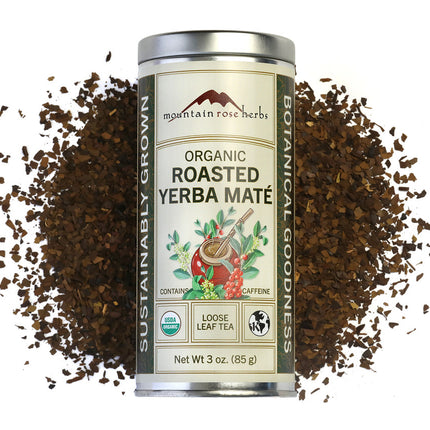 Canister of Organic Roasted Yerba Mate with scattered grounds on a white background, Raven's Cauldron, 6 N. Sandusky St, Delaware, OH 43015