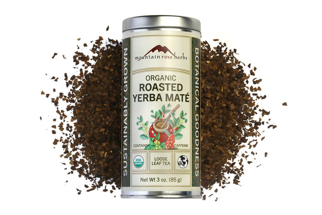Canister of Organic Roasted Yerba Mate with scattered grounds on a white background, Raven's Cauldron, 6 N. Sandusky St, Delaware, OH 43015