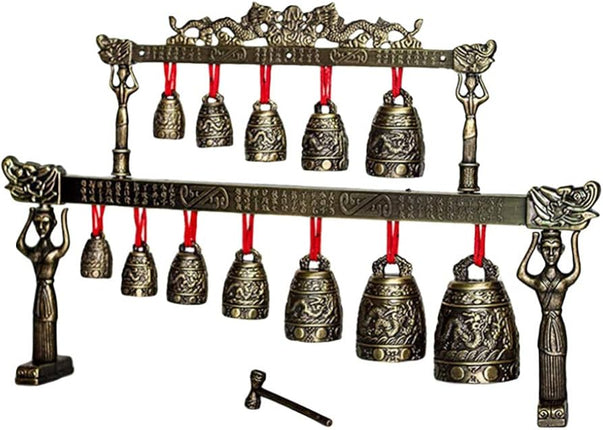 Decorative bell set with bronze finish and red strings on a white background from Raven's Cauldron 6 N Sandusky St. Delaware ohio 43015