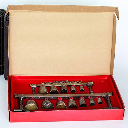 Decorative bell set with bronze finish and red strings on a white background from Raven's Cauldron 6 N Sandusky St. Delaware ohio 43015