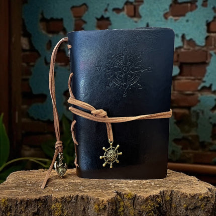 black leather notebook with compass design and decorative strap Raven's Cauldron,  6 N. Sandusky St, Delaware, OH 43015
