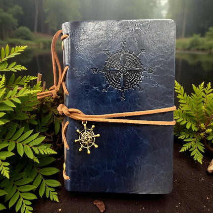 blue leather journal with nautical compass and leather cord with ship wheel charm
