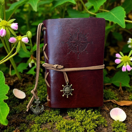 Brown leather journal with compass design on a natural background Raven's Cauldron,  6 N. Sandusky St, Delaware, OH 43015