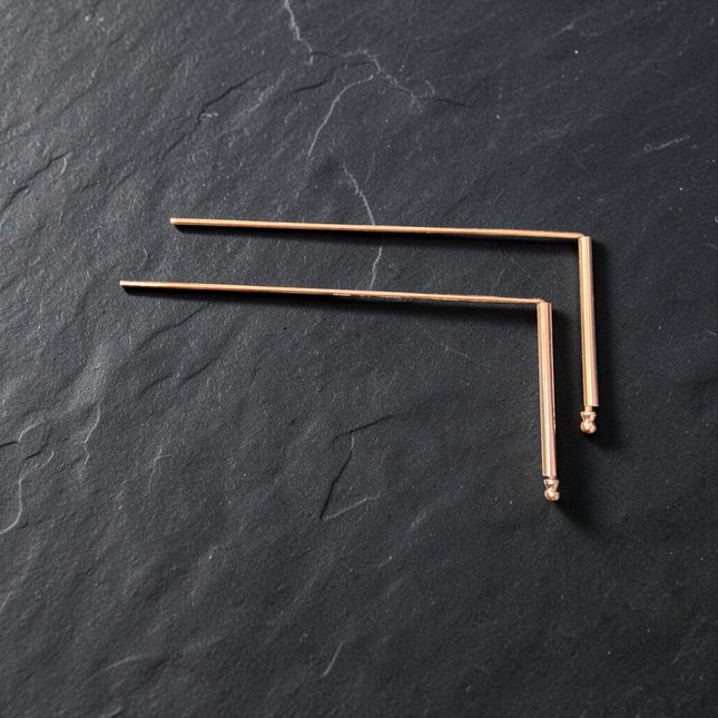 Copper dowsing rods set with two solid copper L-rods measuring 9.5 x 4.5 inches for divination, energy work, water dowsing, and intuitive practice.