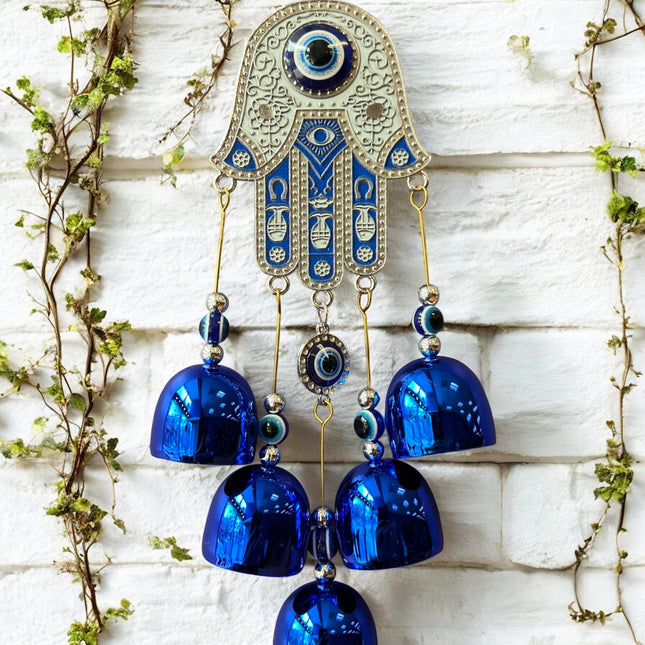 Brass Evil Eye Wind Chimes with five bells and Hand of Hamsa design, measuring 17 inches in length, hanging against a neutral background.