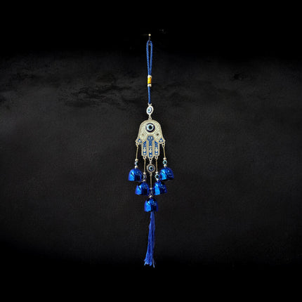 Brass Evil Eye Wind Chimes with five bells and Hand of Hamsa design, measuring 17 inches in length, hanging against a neutral background.