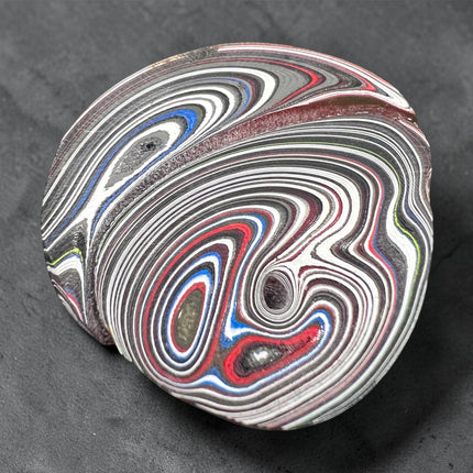 Polished Fordite Detroit Motor City Agate stone with colorful layered bands measuring 1.5 inches , Raven's Cauldron, 6 N Sandusky St, Delaware, OH 43015