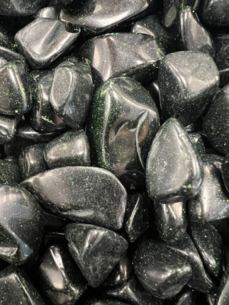 Green Goldstone tumbled stone with sparkling metallic flecks, polished finish, approximately 1 inch, photographed on a white background.