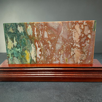 Ocean Jasper polished slab with orb patterns on wooden stand crystal display Raven's Cauldron, Delaware, OH