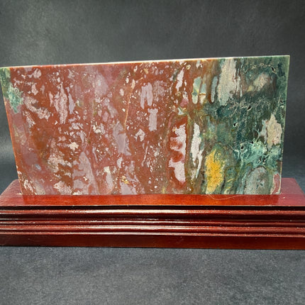 Ocean Jasper polished slab with orb patterns on wooden stand crystal display Raven's Cauldron, Delaware, OH