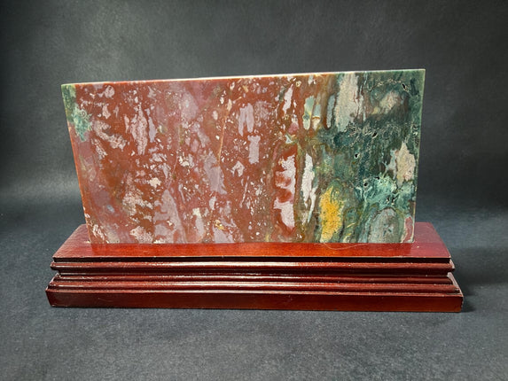 Ocean Jasper polished slab with orb patterns on wooden stand crystal display Raven's Cauldron, Delaware, OH