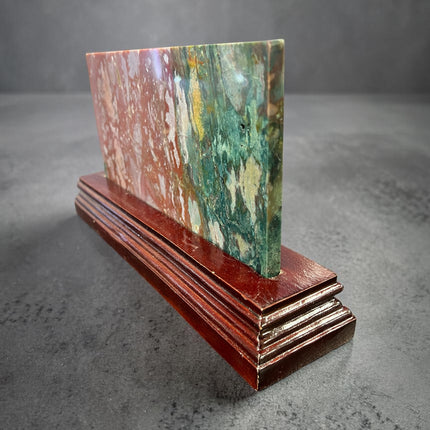 Ocean Jasper polished slab with orb patterns on wooden stand crystal display Raven's Cauldron, Delaware, OH