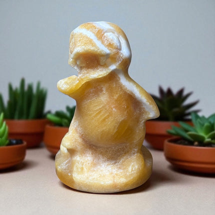 5-inch hand-carved Orange Stripe Calcite Charmander with bold orange and white banding, polished to a high shine
