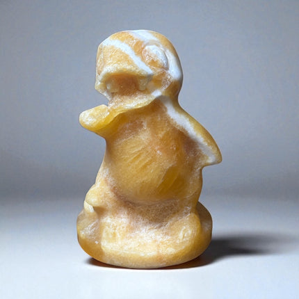 5-inch hand-carved Orange Stripe Calcite Charmander with bold orange and white banding, polished to a high shine