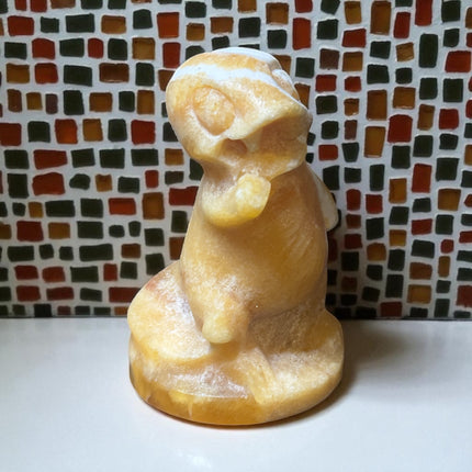 5-inch hand-carved Orange Stripe Calcite Charmander with bold orange and white banding, polished to a high shine