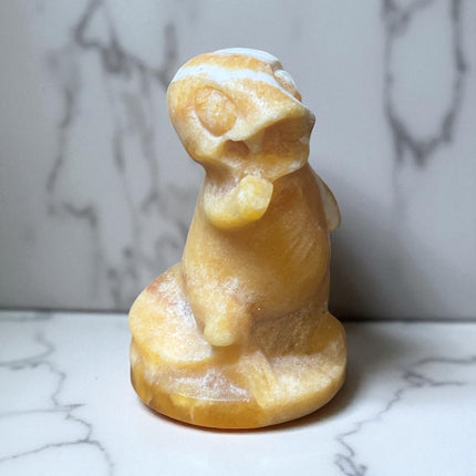 5-inch hand-carved Orange Stripe Calcite Charmander with bold orange and white banding, polished to a high shine