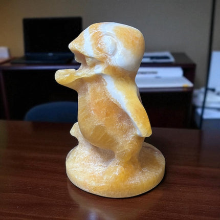 5-inch hand-carved Orange Stripe Calcite Charmander with bold orange and white banding, polished to a high shine