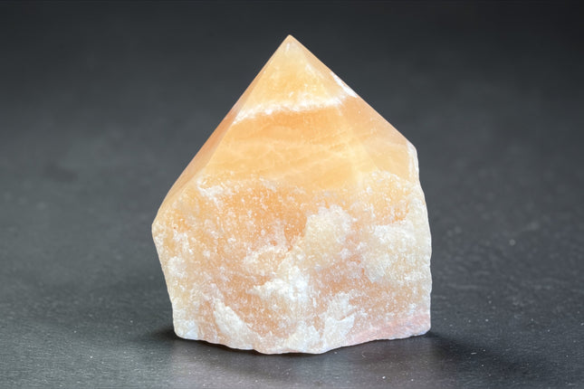 Orange Calcite semi-polished crystal point for creativity and solar plexus chakra energy from Raven's Cauldron, 6 N Sandusky St, Delaware, OH 43015