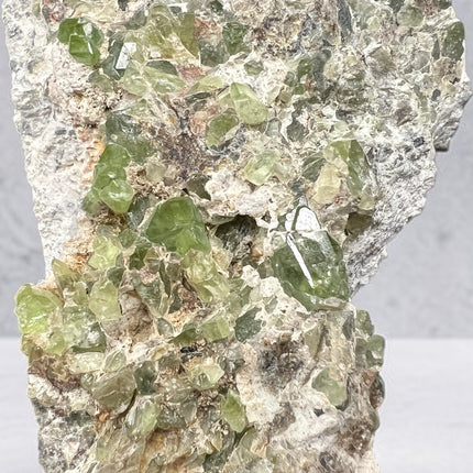 Natural Peridot in Matrix crystal specimen from Pakistan weighing 210 grams with vibrant green Peridot crystals in host rock – Raven's Cauldron, Delaware, OH

Secondary Image Alt Text: