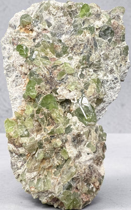 Natural Peridot in Matrix crystal specimen from Pakistan weighing 210 grams with vibrant green Peridot crystals in host rock – Raven's Cauldron, Delaware, OH

Secondary Image Alt Text: