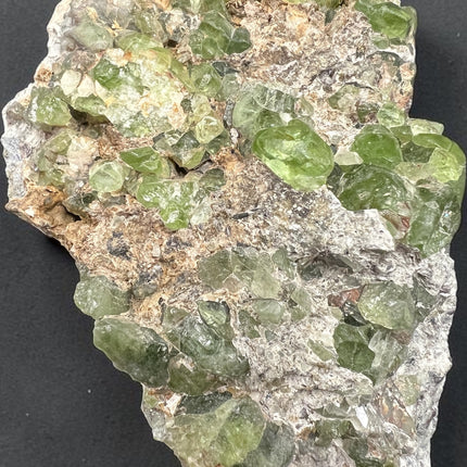 Large Peridot in Matrix mineral specimen from Pakistan with abundant natural green Peridot crystals embedded throughout the matrix – Raven's Cauldron, Delaware, OH