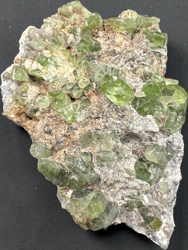 Large Peridot in Matrix mineral specimen from Pakistan with abundant natural green Peridot crystals embedded throughout the matrix – Raven's Cauldron, Delaware, OH