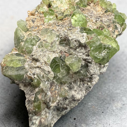 Large Peridot in Matrix mineral specimen from Pakistan with abundant natural green Peridot crystals embedded throughout the matrix – Raven's Cauldron, Delaware, OH