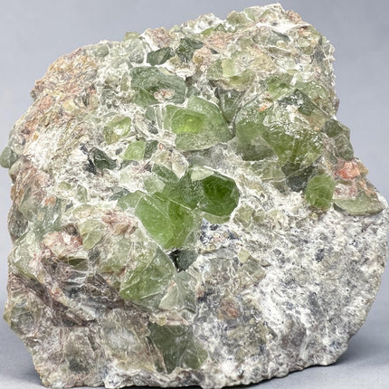 Natural Peridot in Matrix crystal specimen from Pakistan weighing 307 grams with vibrant green Peridot crystals in host rock, Raven's Cauldron, Delaware, OH.