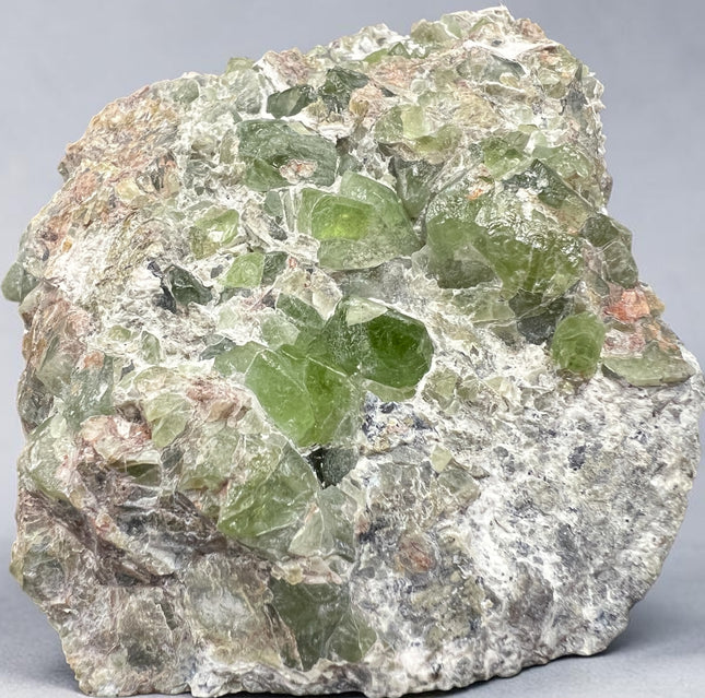 Natural Peridot in Matrix crystal specimen from Pakistan weighing 307 grams with vibrant green Peridot crystals in host rock, Raven's Cauldron, Delaware, OH.