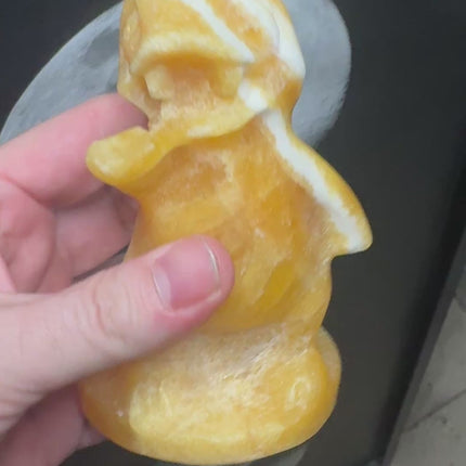 5-inch hand-carved Orange Stripe Calcite Charmander with bold orange and white banding, polished to a high shine