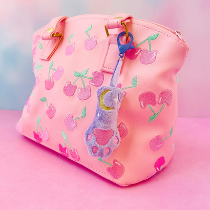 Purple celestial cat paw plush bag charm astrology accessory by Kawaii Hair Candy shown on bag
