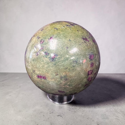 Large polished Ruby in Fuchsite crystal sphere weighing 1931 grams and measuring approximately 3.75 inches, featuring vibrant green fuchsite with natural deep ruby inclusions.