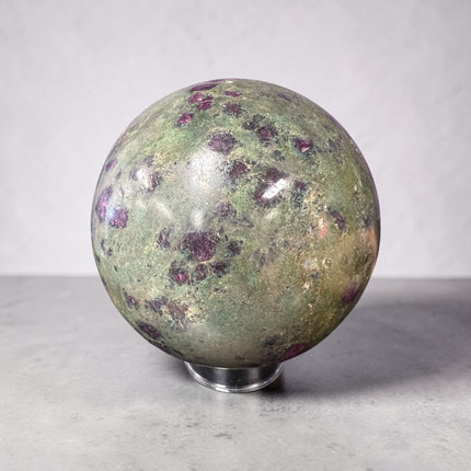 Large polished Ruby in Fuchsite crystal sphere weighing 1931 grams and measuring approximately 3.75 inches, featuring vibrant green fuchsite with natural deep ruby inclusions.