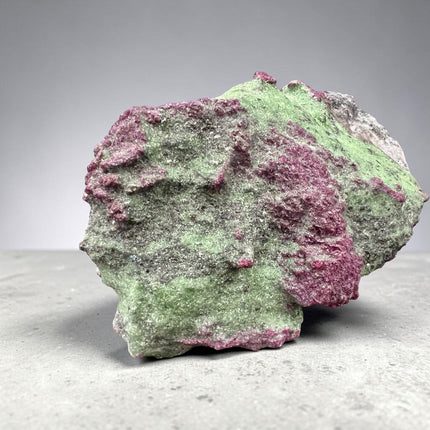 Collector's grade 2,230 gram Ruby in Zoisite featuring vibrant low-iron raw ruby crystal clusters within natural green zoisite matrix displayed as a one-of-a-kind mineral specimen.
