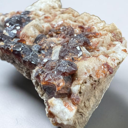 Natural Spessartine Garnet crystal specimen from Pakistan weighing 152 grams with vibrant orange garnet crystals, Raven's Cauldron, Delaware, OH.