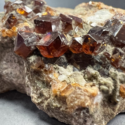 Natural Spessartine Garnet specimen on matrix featuring large crystal formations from Pakistan measuring 2.5 inches, Raven's Cauldron, Delaware, OH