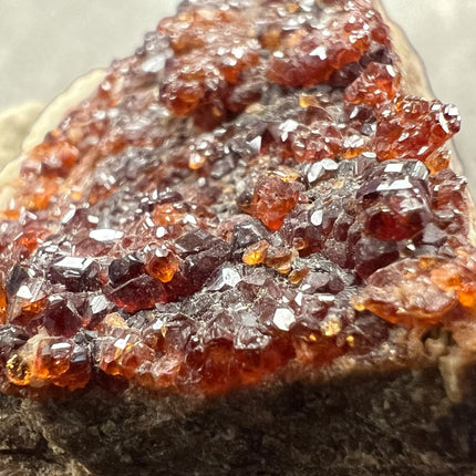 Natural Spessartine Garnet on matrix mineral specimen featuring druzy crystal clusters from Pakistan, Raven's Cauldron, Delaware, OH