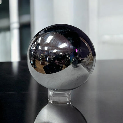 Reflective metallic sphere on a stand with blurred indoor background terahertz sphere ,Ravens Cauldron, 6 N Sandusky St, Delaware, OH 43015