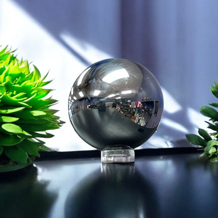 Silver reflective sphere on a dark surface with green plants terahertz sphere ,Ravens Cauldron, 6 N Sandusky St, Delaware, OH 43015