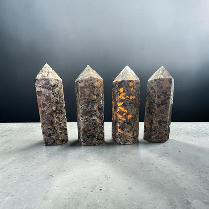Natural 3-inch Yooperlite tower polished into facets with hidden orange fluorescence under ultraviolet light.