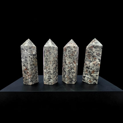 Natural 3-inch Yooperlite tower polished into facets with hidden orange fluorescence under ultraviolet light.