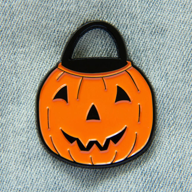 Vintage Halloween Bucket Pin – Ectogasm Vintage Halloween Bucket Enamel Pin, designed by Raeha Keller, enamel/metal, 1–2 inches. Raven's Cauldron, 6 N. Sandusky St, Delaware, OH 43015