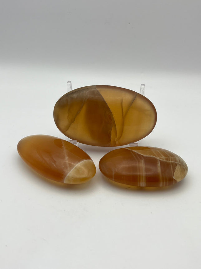 Honey Calcite Palm Stone - Raven's Cauldron